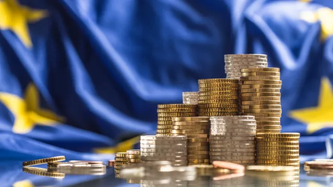 EU flag and stack of coins
